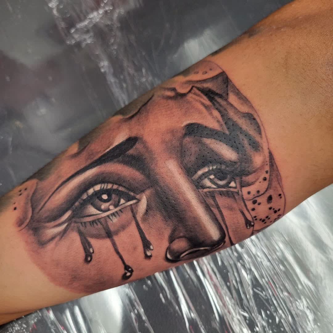 Black and grey realism portrait with tears tattoo on forearm